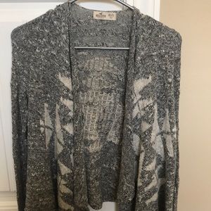 Small grey sweater with white design.